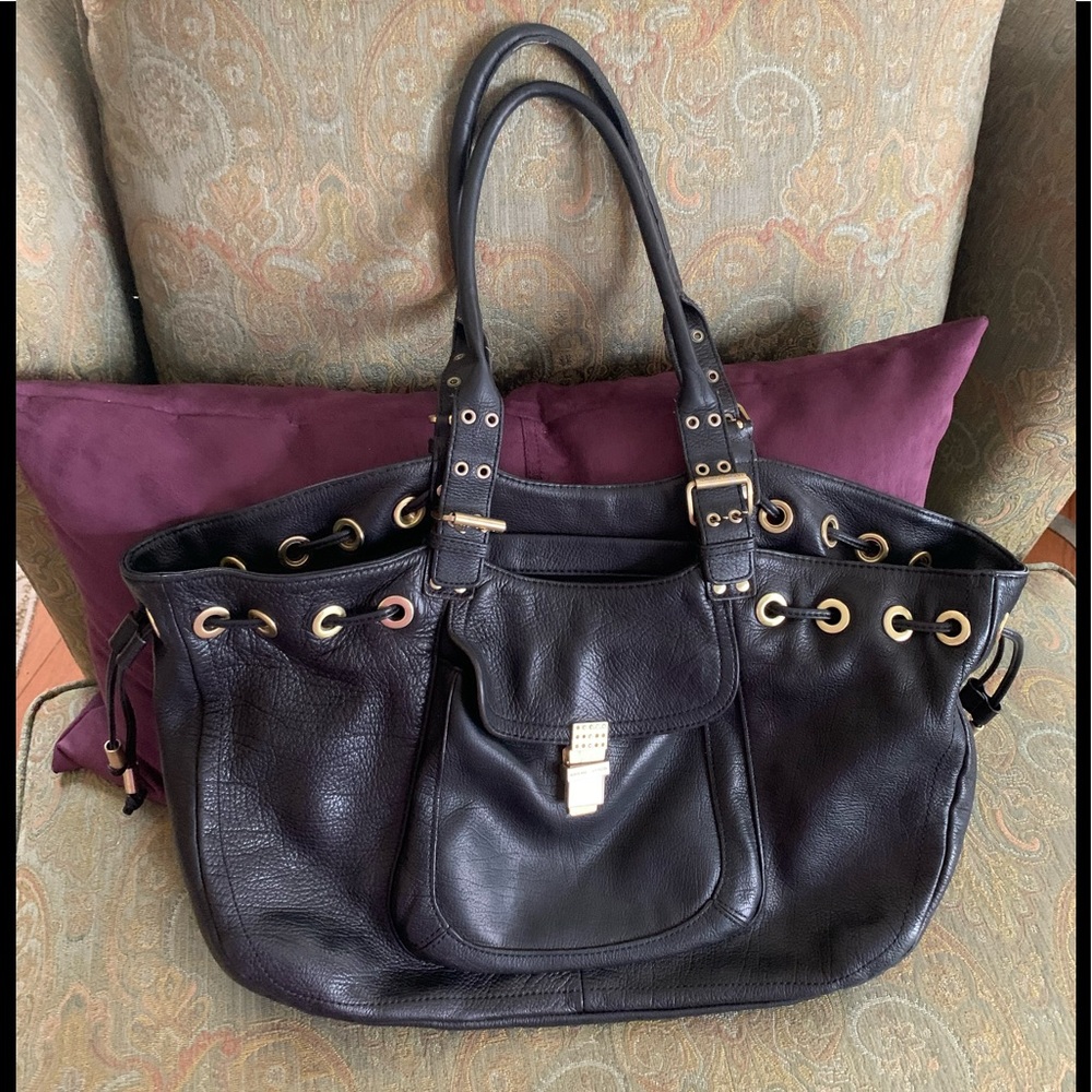 Genuine leather handbag with adornments on the front clasp